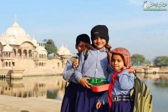Happy faces of children studying in a school at Kusum Sarovar, Barsana