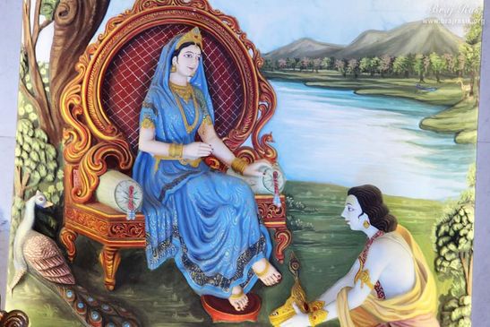 Lord Krishna puts His crown on the lotus feet of Shri Radha.