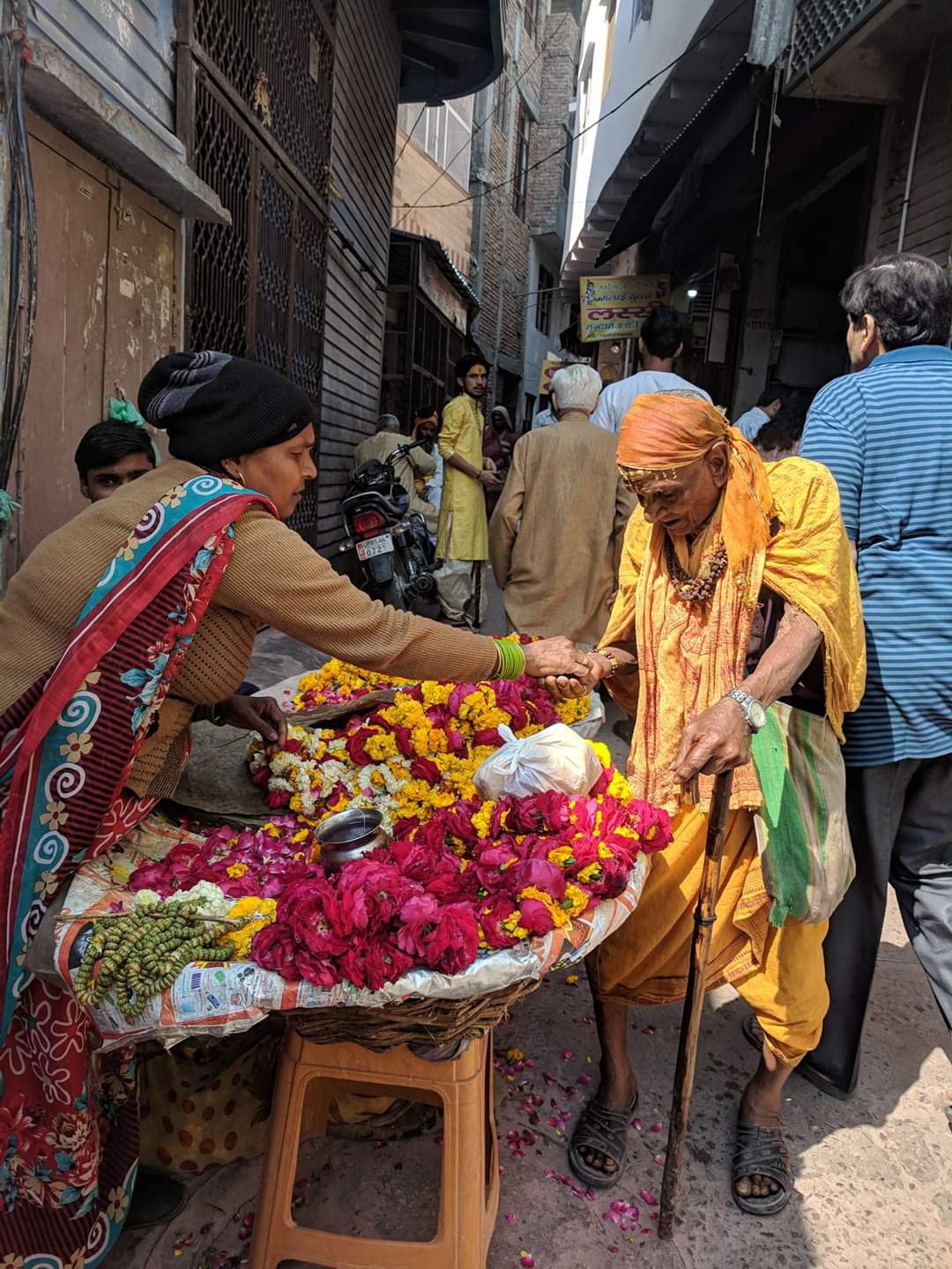 Devotee taking Prasad near Shri Banke Bihari Temple, Vrindavan.