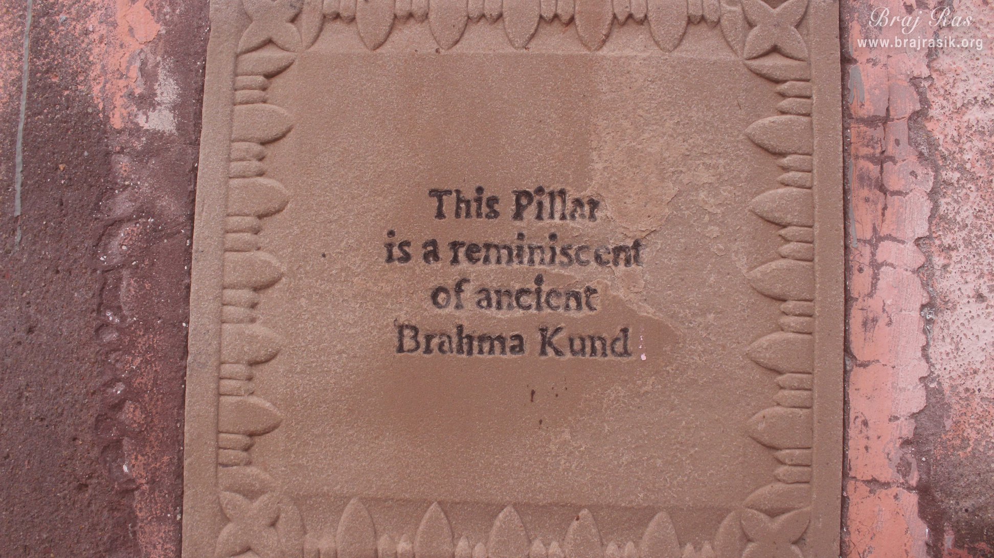 Information board on an ancient pillar at Brahma Kund.