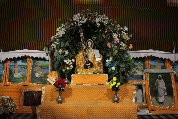 Front darshan of Swami Haridas Ji in yellow attire at Swami Haridas Kunj Kuti, Vrindavan