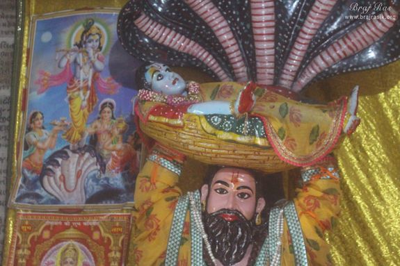 Shri Vasudev Ji crossing Yamuna carrying Shri Krishna and Sheshnaag protecting lord from rain in Gokul Mahavan