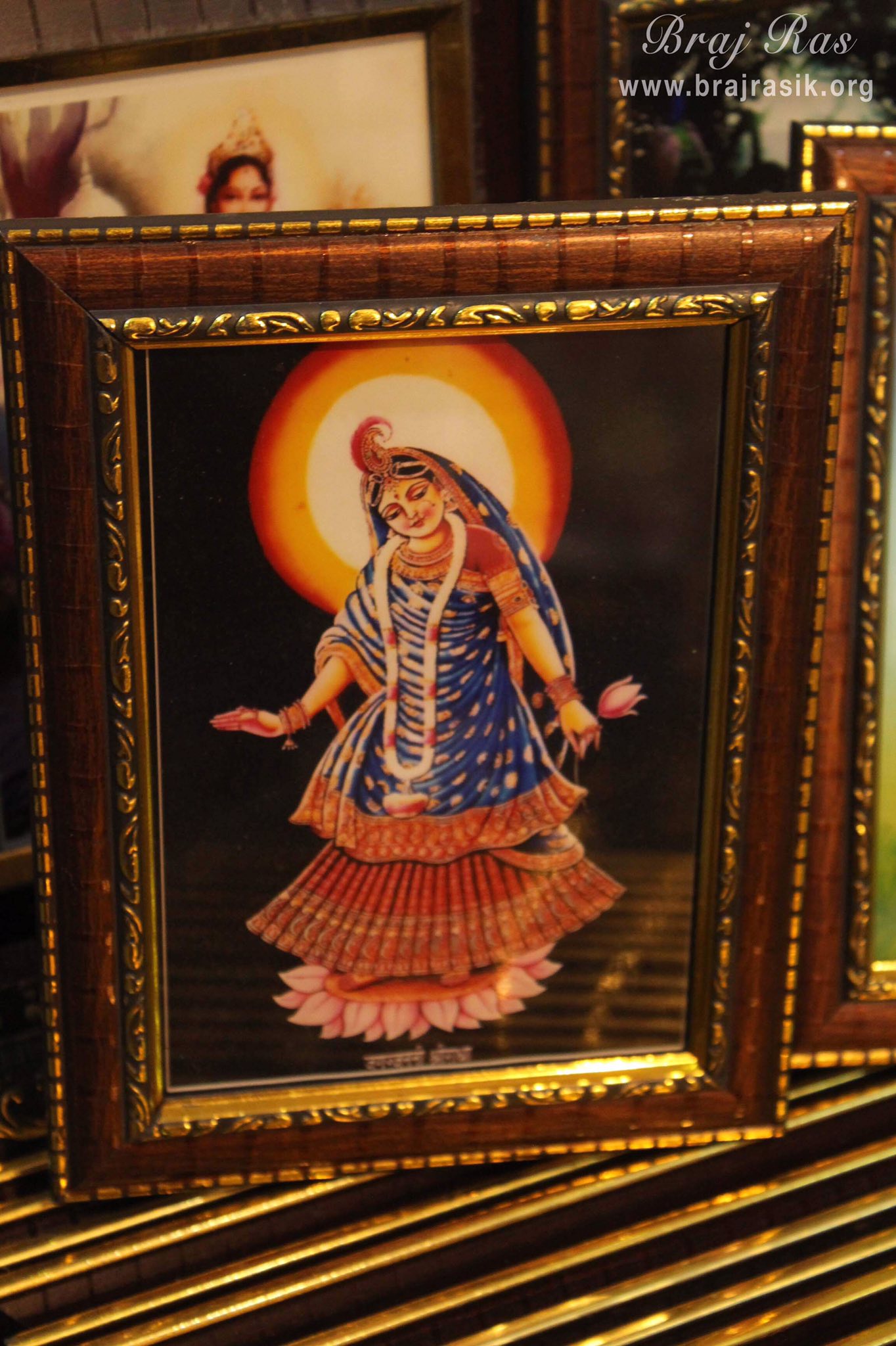 Photoframe of Shri Radharani holding pink lotus in her left hand in Banke Bihari Gali, Vrindavan