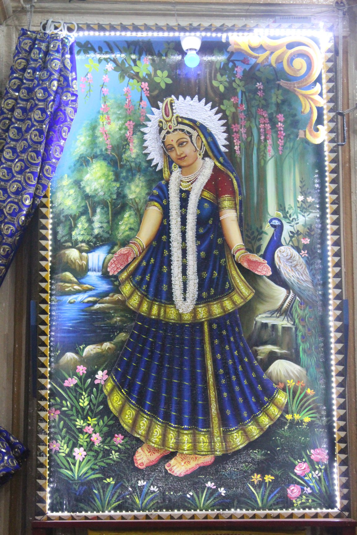Photoframe of Shri Radharani with blue curtains in Banke Bihari Gali, Vrindavan