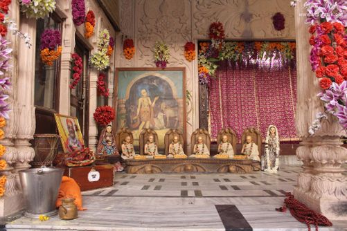 Distant view of Chaitanya Mahaprabhu Portrait stand with statue of Six goswami at Shri Radha Damodar Temple, Vrindavan