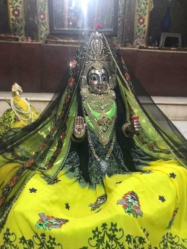 Darshan of Lord Shiva in a gopi form in yellow attire at Shri Gopeshwar or Gopishwar Mahadev, Vrindavan