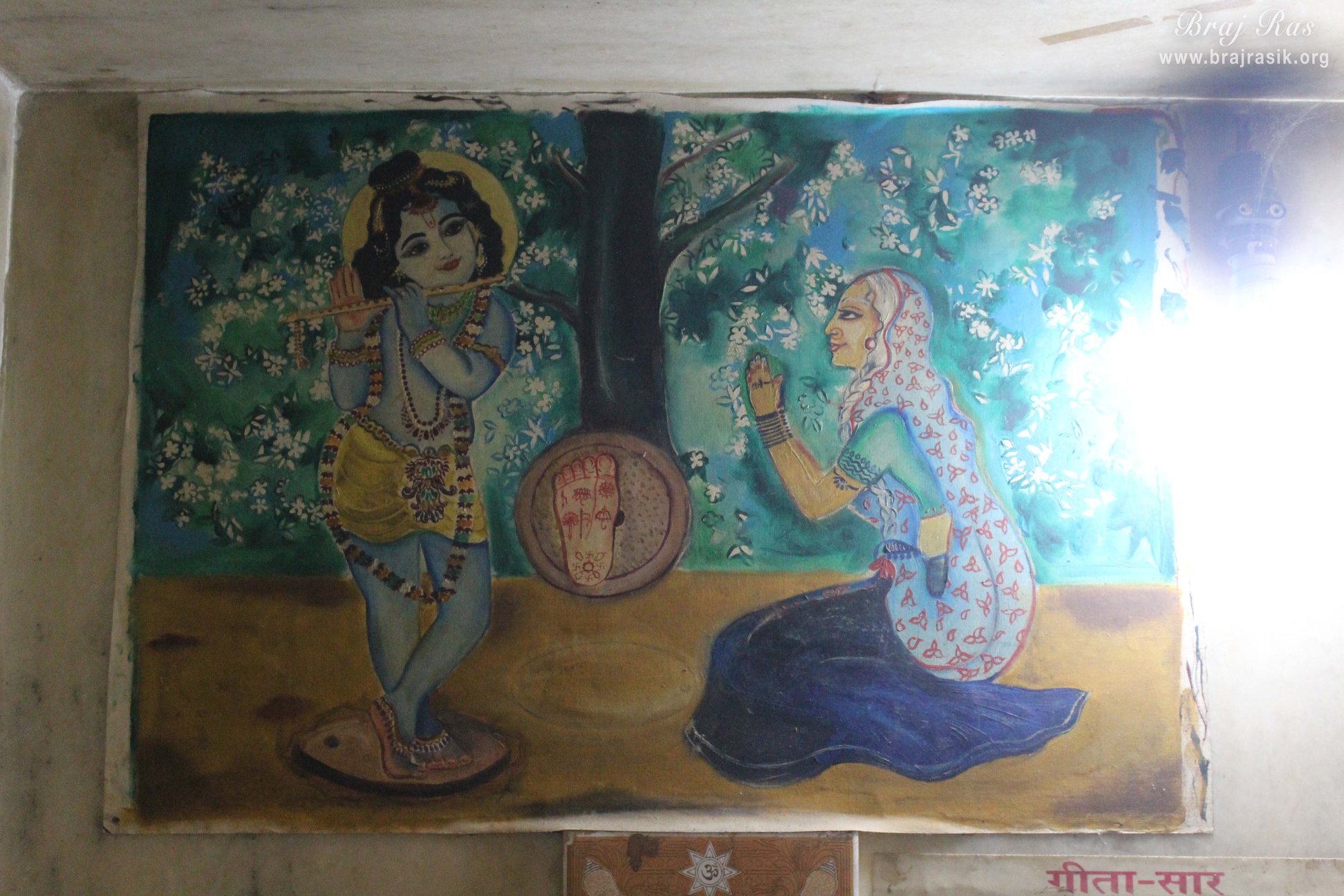 Painting of an old lady who was a devotee of Shri Krishna and Shri Krishna gave his footprints on a grindstone to her at Jhadu Mandal, Vrindavan