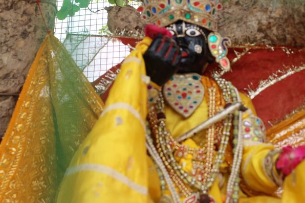 Close darshan of Shri Krishna in yellow attire at Chir Ghat or Cheer Ghat, Vrindavan