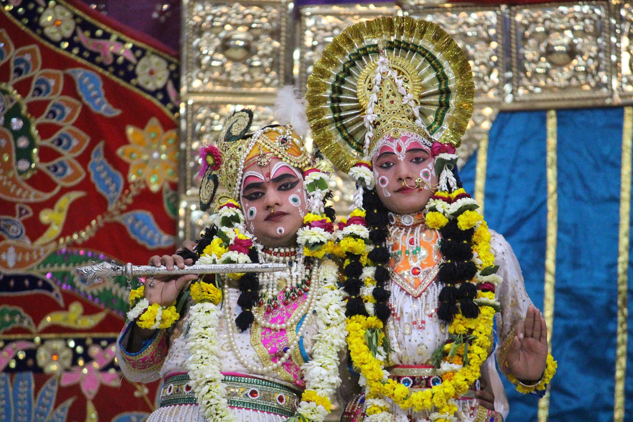 Darshan of Shri Radharani and Shri Krishna holding flute in white attire at Raas Leela Moments, Vrindavan