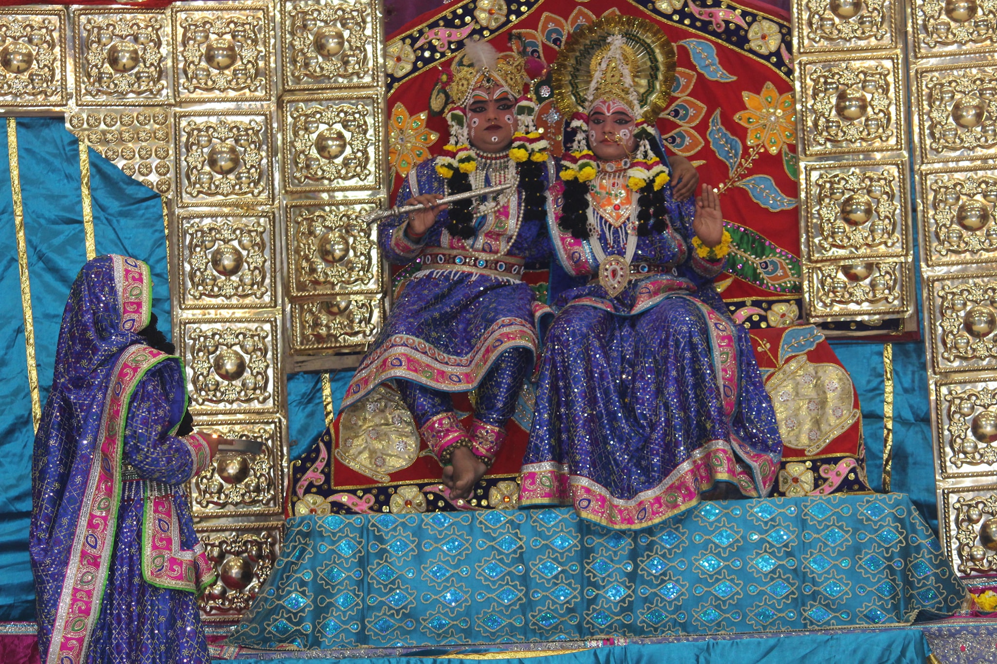 Darshan of Shri Radha Krishna in blue attire seated on throne at Raas Leela Moments, Vrindavan