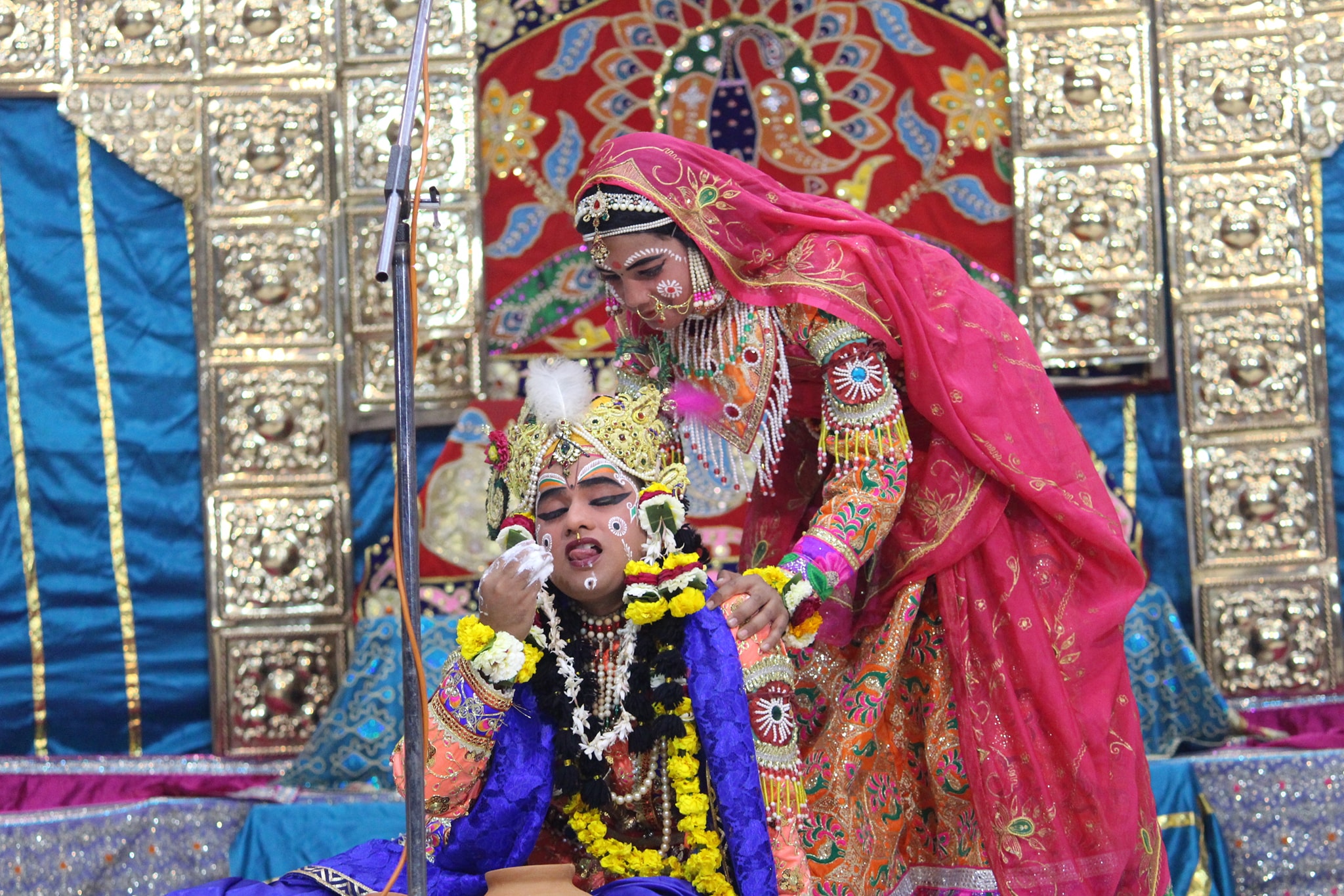 Darshan of Shri Krishna eating butter from a pot at Raas Leela Moments, Vrindavan
