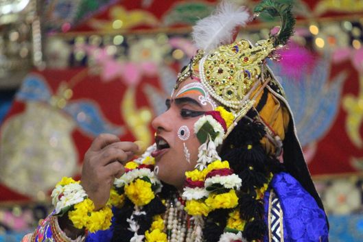 Darshan of Shri Krishna eating food remnants left by Shri Radharani at Raas Leela Moments, Vrindavan
