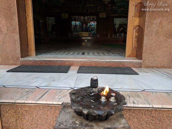 Deity darshan from the gate of the temple at Imlitala, Vrindavan.
