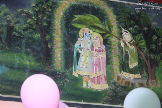 Radha Krishna painting at Old Ras Mandal or Hit Ras Mandal, Vrindavan where a sakhi is protecting Shri Radha Krishn from rain.