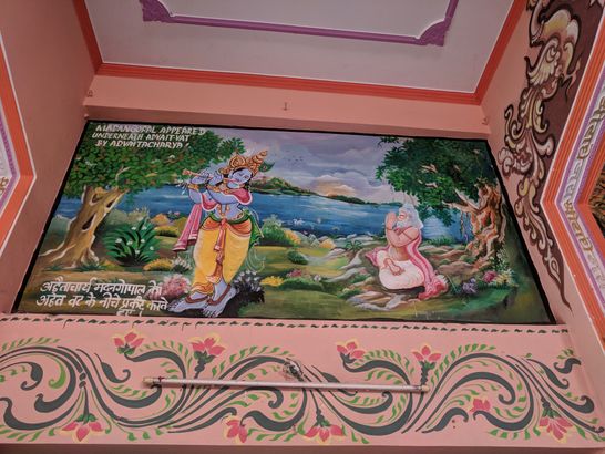 The painting of Shri Advaita Acharya making Lord Madan Gopal appear under Advaita Vata tree depicted on the wall of the temple at Advaita Vata, Vrindavan