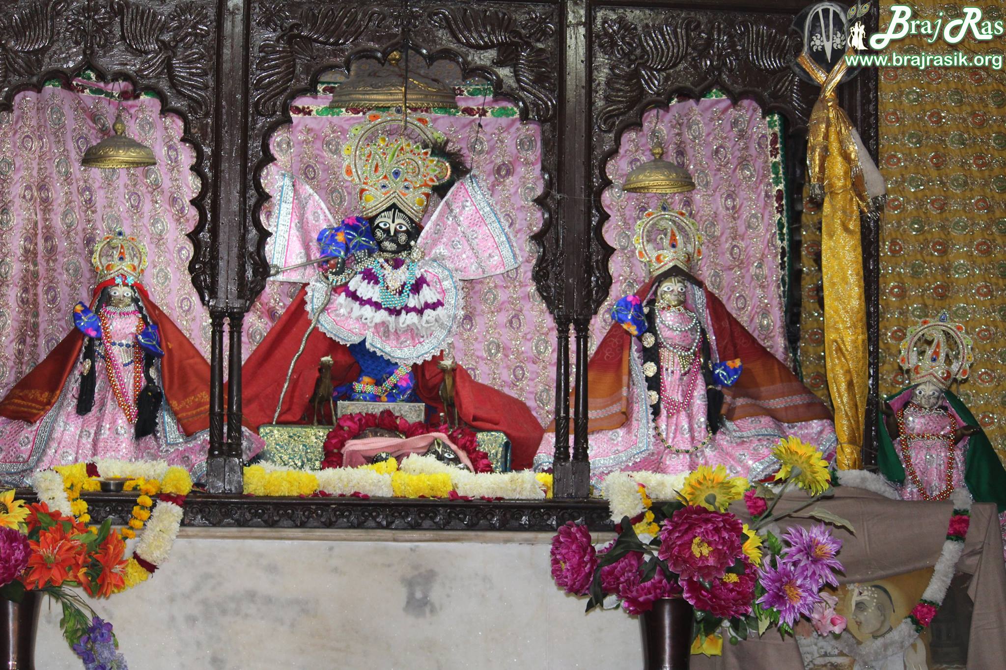 Shri Gopinath Ji with Shri Radharani on right and Jahnava Thakurani on left and a small Shri Radharani on extreme right at Shri Radha Gopinath Ji, Vrindavan