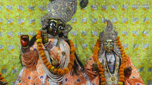 Close darshan of Shri Radha Krishna in light orange attire at Shriji Ka Mandir, Vrindavan