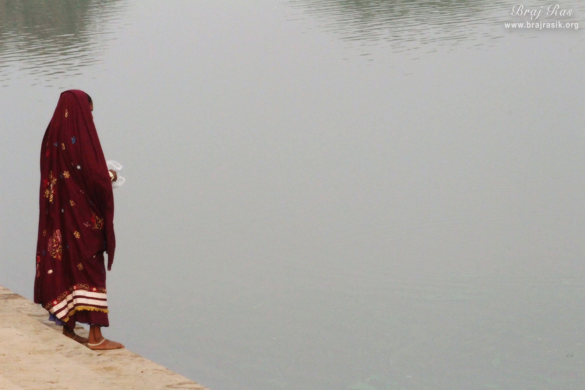 A devotee standing at Deha Kunda, Braj