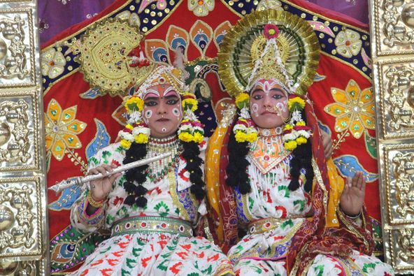 Close darshan of Shri Radha Krishna in white attire seated on a throne in Raas Leela, Vrindavan