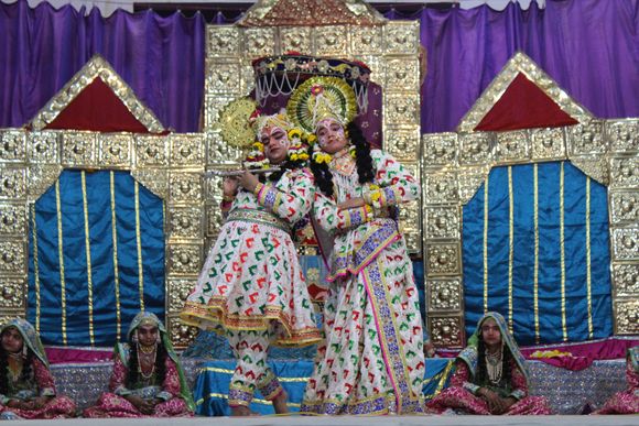 Darshan of Shri Radha Krishna standing in white attire doing a Leela pastime in Raas Leela, Vrindavan