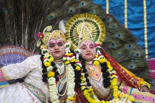 Darshan of Shri Radha Krishna in white attire doing Leela pastime of peacock dance in Raas Leela, Vrindavan