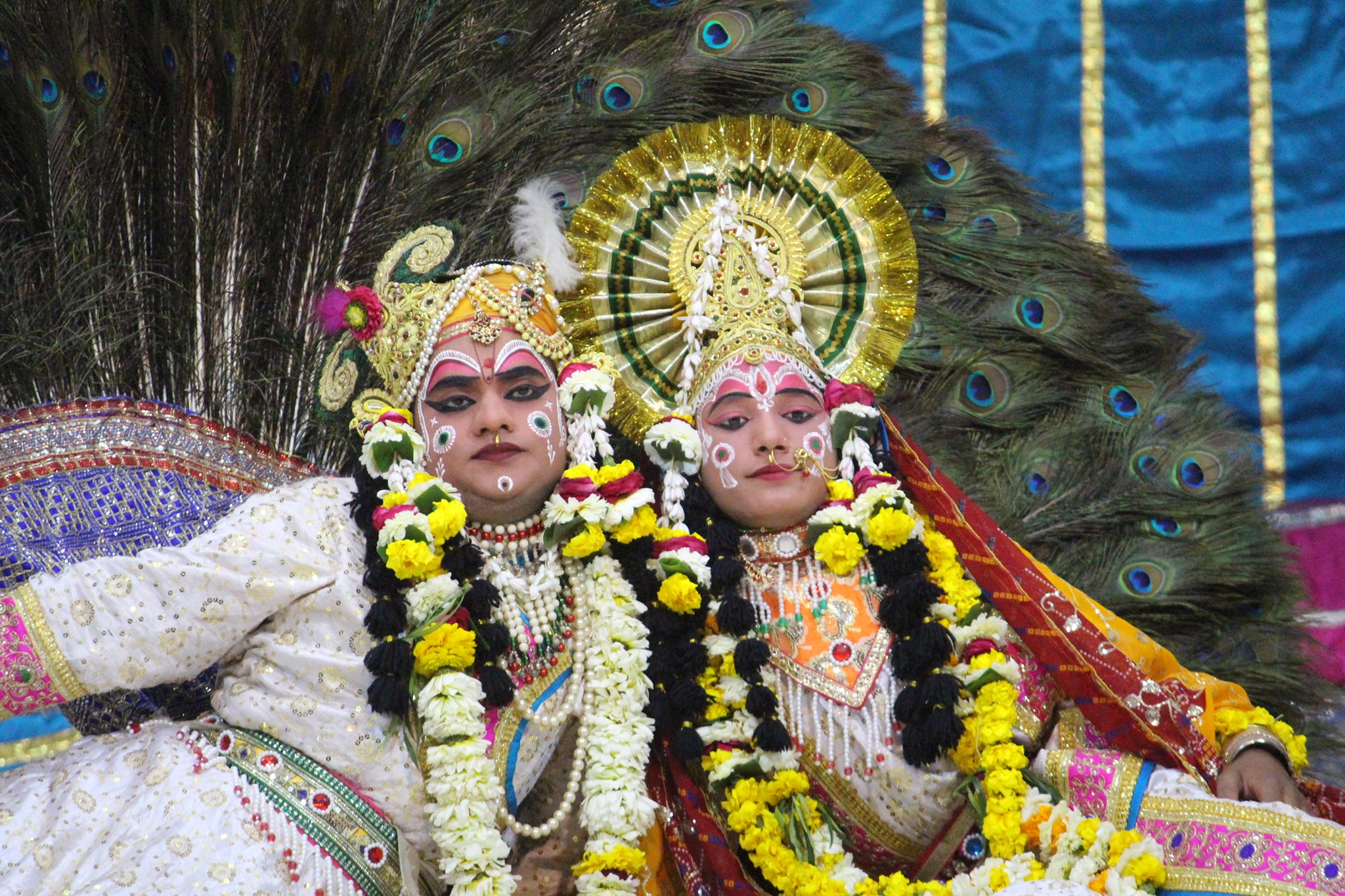 Darshan of Shri Radha Krishna in white attire doing Leela pastime of peacock dance in Raas Leela, Vrindavan