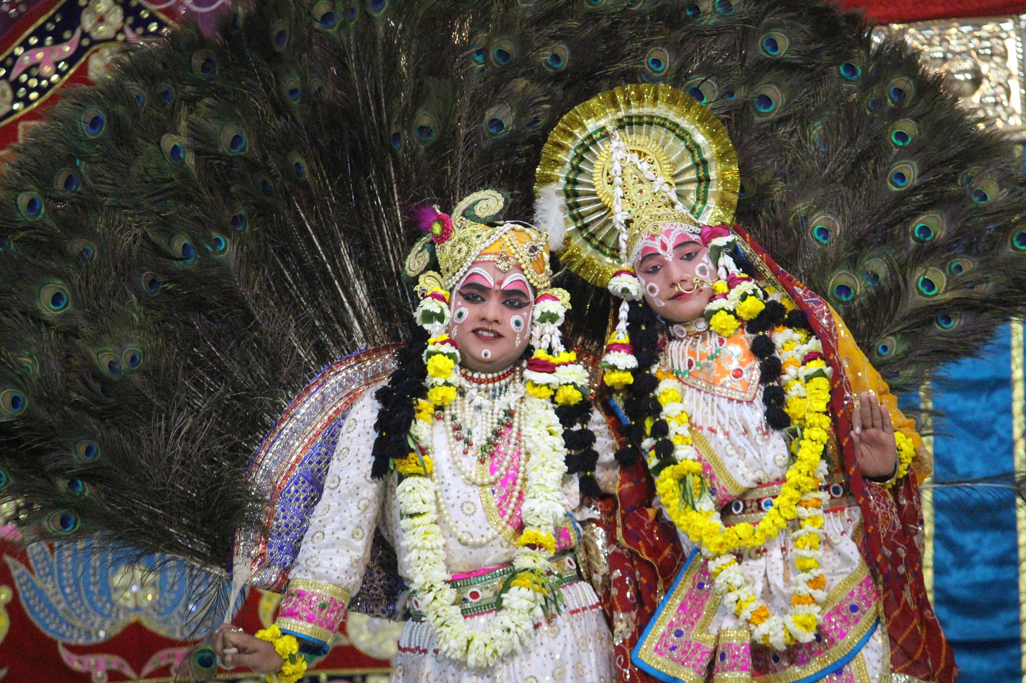 A nice darshan of Shri Radha Krishna in white attire doing Leela pastime of peacock dance in Raas Leela, Vrindavan
