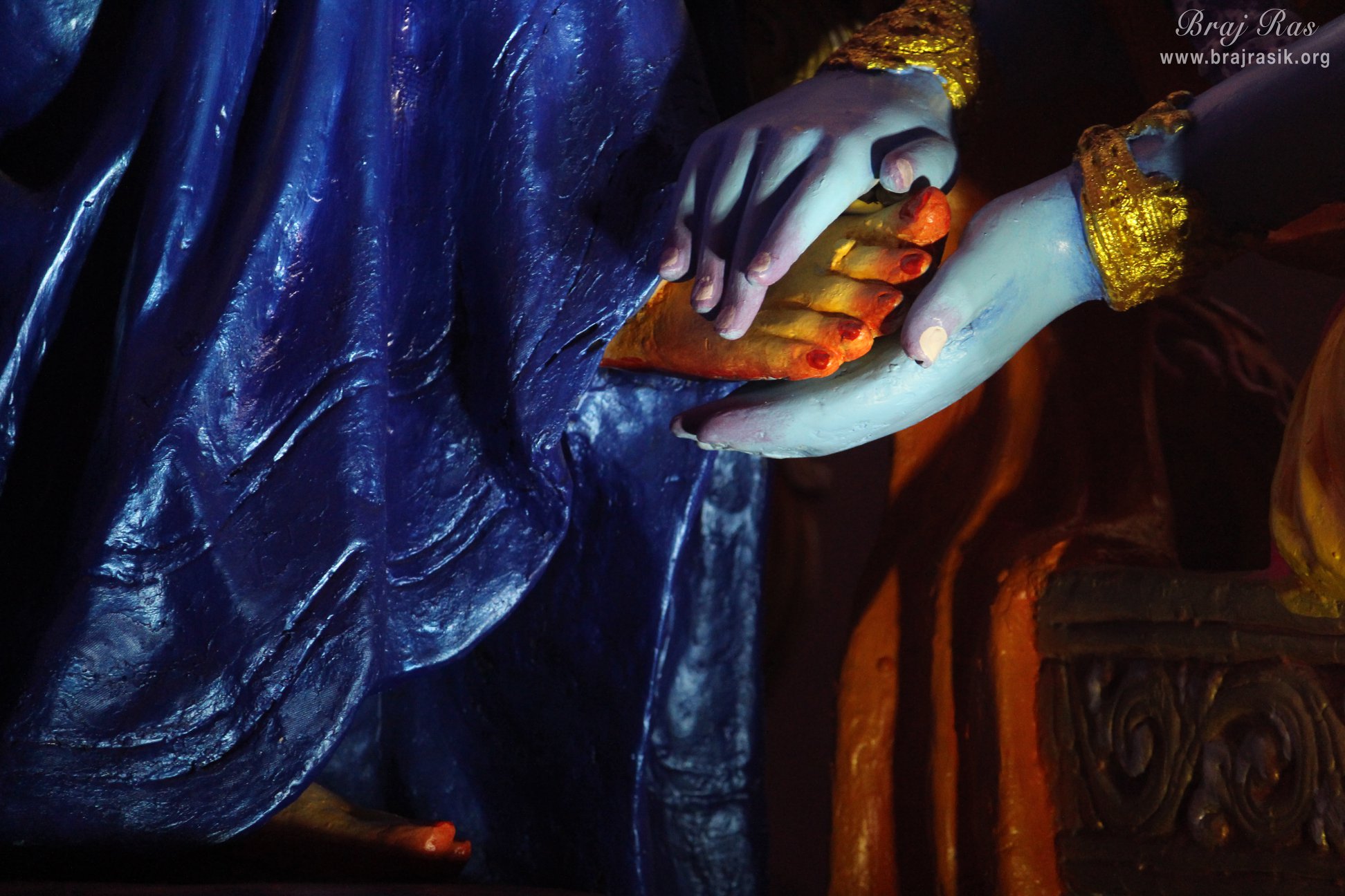 Shri Radha lotus feet in the hands of Shri Krishn at Prem Mandir, Vrindavan