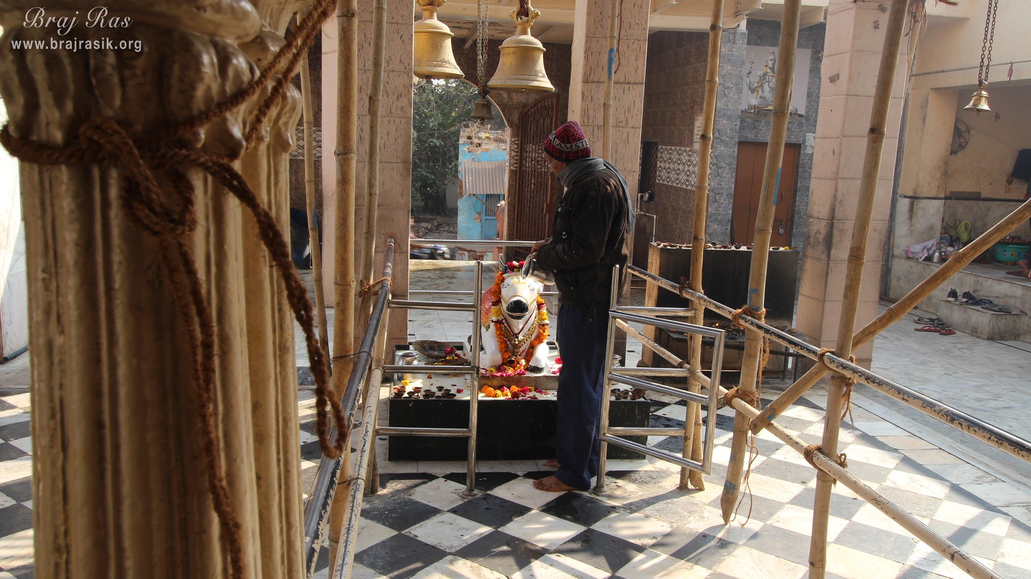 A devotee of Lord is offering water to Nandi at Bhuteshwar Mahadev Temple, Mathura