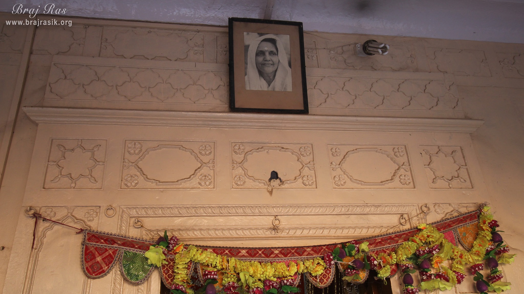 Photo of Maa Anandamayi above the door of temple at Shri Vrindavan Vihari Temple, Vardhman Kunj, Vrindavan