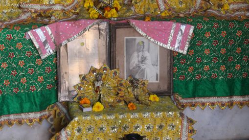 Photo of Maa Anandamayi below deities at Shri Vrindavan Vihari Temple, Vardhman Kunj, Vrindavan