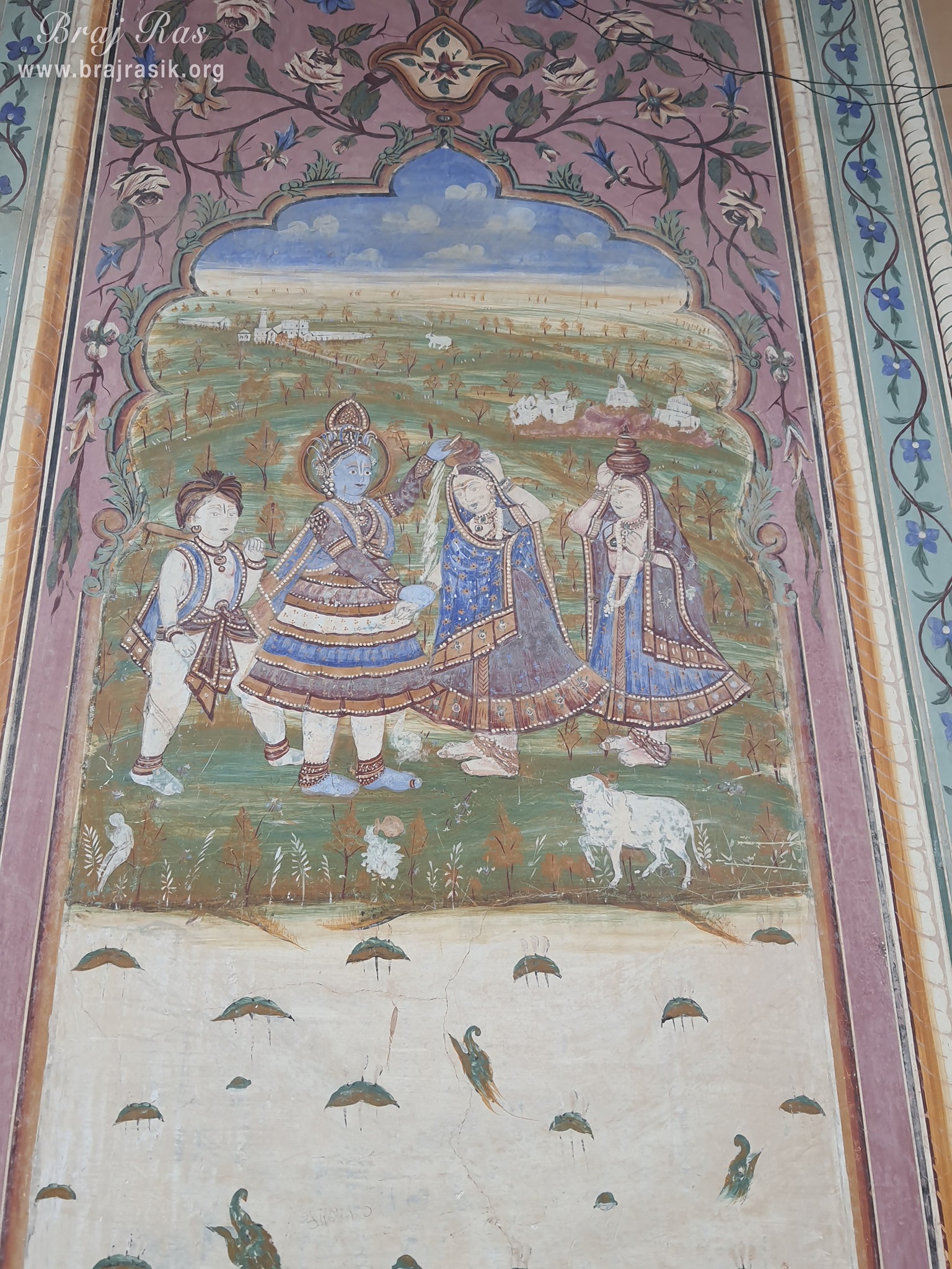 Painting of Shri Krishna stealing butter of milkmaids depicted on the wall at Shri Kushal Bihari Temple, Barsana
