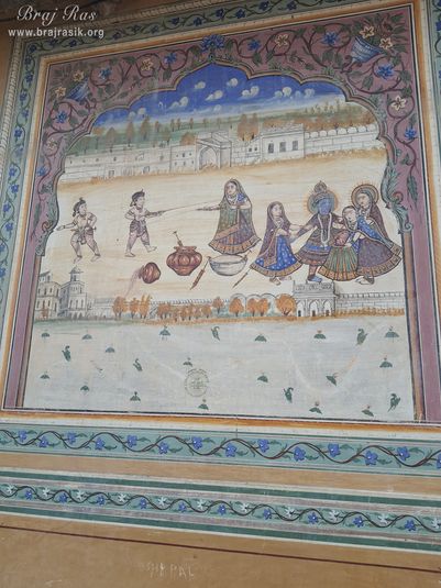Painting of Shri Radha Krishna performing holi pastimes depicted on the wall at Shri Kushal Bihari Temple, Barsana