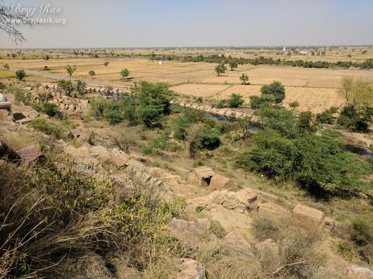 A unique view of nearby fields from the hill at Vyomasur's Cave in Kamyavan.