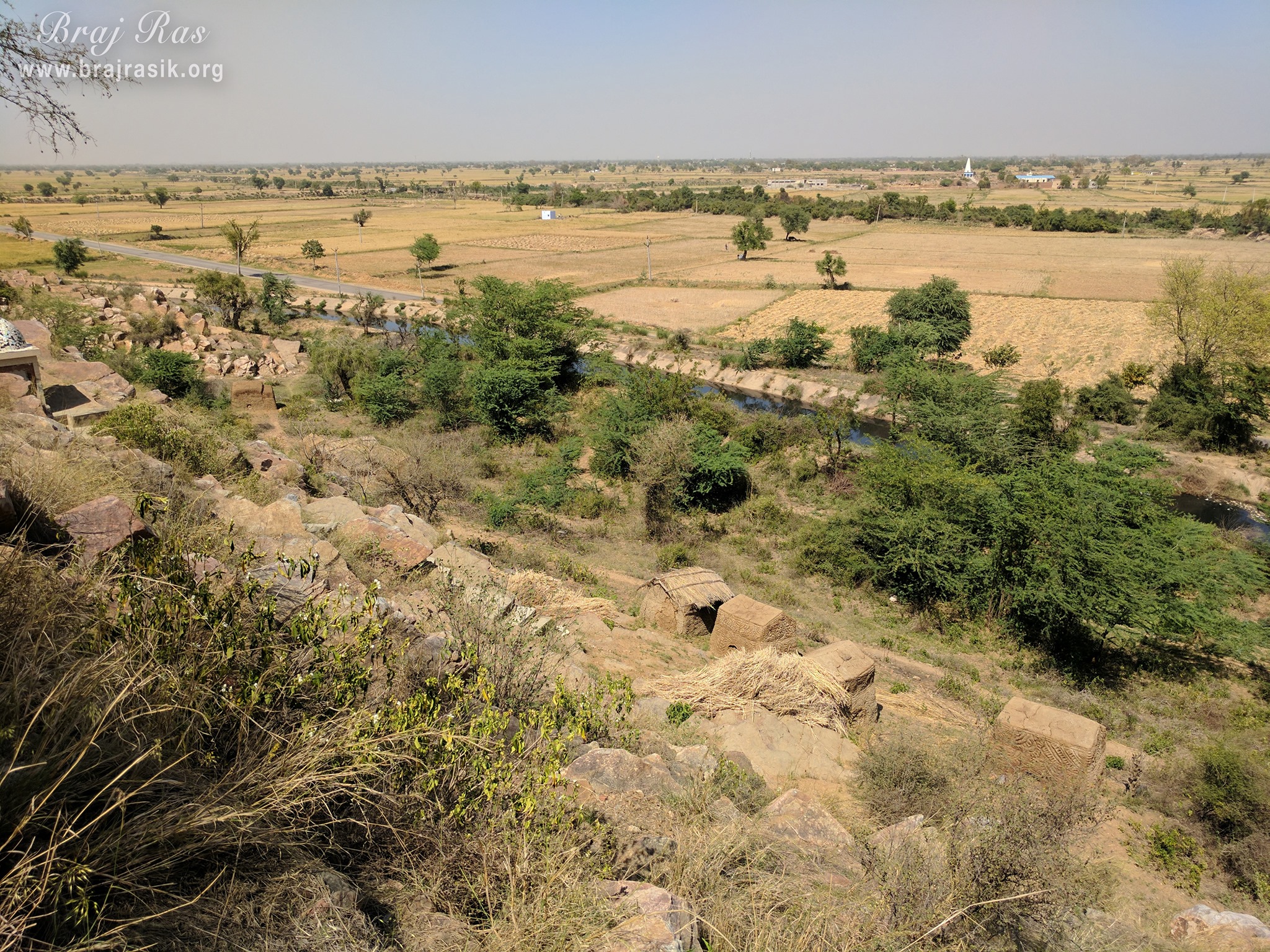 A unique view of nearby fields from the hill at Vyomasur's Cave in Kamyavan.