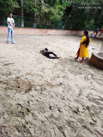 Devotees feeling blessed in the sand of Ramanreti, Gokul - Braj.