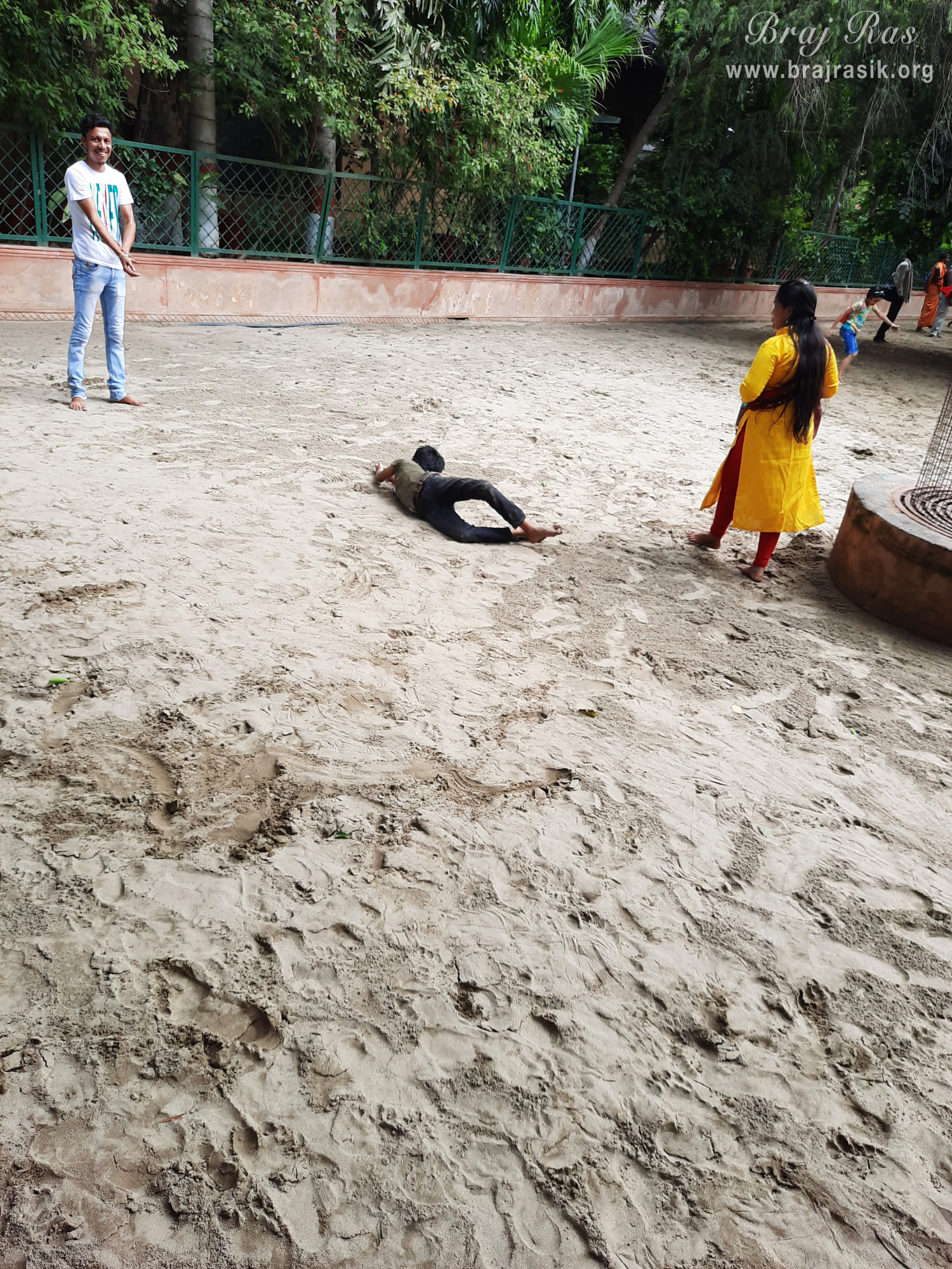 Devotees feeling blessed in the sand of Ramanreti, Gokul - Braj.