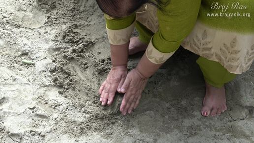 A devotee touching the divine sand at Ramanreti, Gokul - Braj.