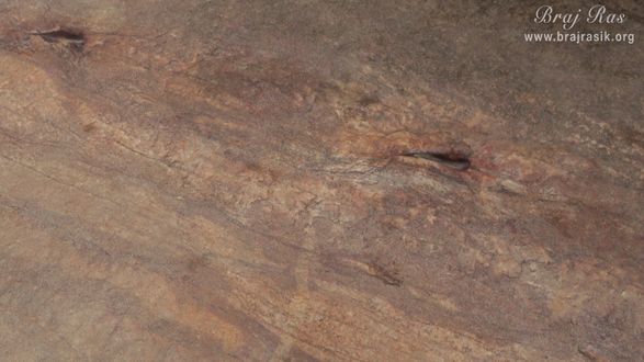 The eyes of Balaram Ji are inscribed on this rock at Mukharvind in Govardhan.