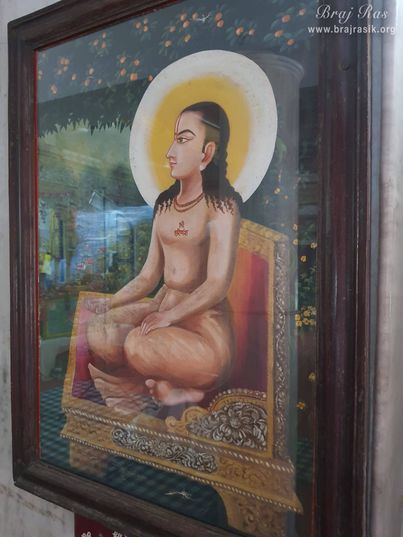 A painting of Shri Sewak Ji (Shri Hita Damodardas Ji) is placed on a wall in Shri Hita Mahal, Vrindavan