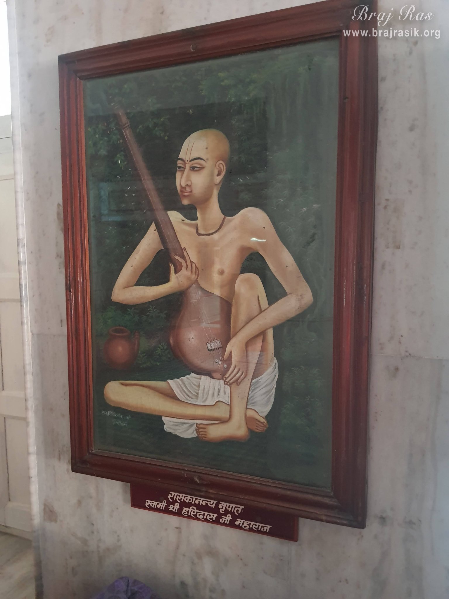 A painting of Shri Swami Haridas Ji is placed on a wall in Shri Hita Mahal, Vrindavan