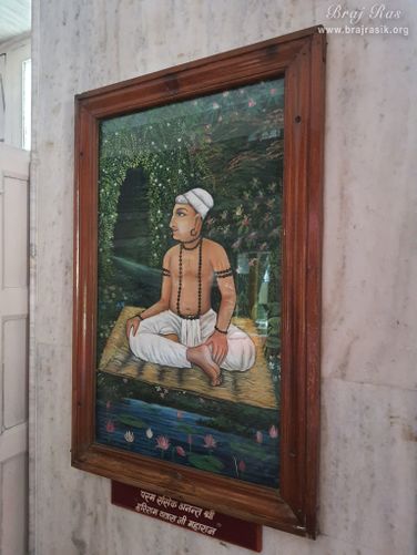 A painting of Shri Hariram Vyas Ji is placed on a wall in Shri Hita Mahal, Vrindavan