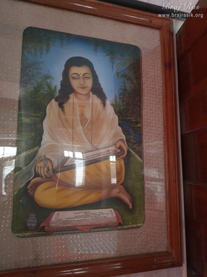 A painting of Shri Hita Dhruvdas Ji is placed on a wall in Shri Hita Mahal, Vrindavan