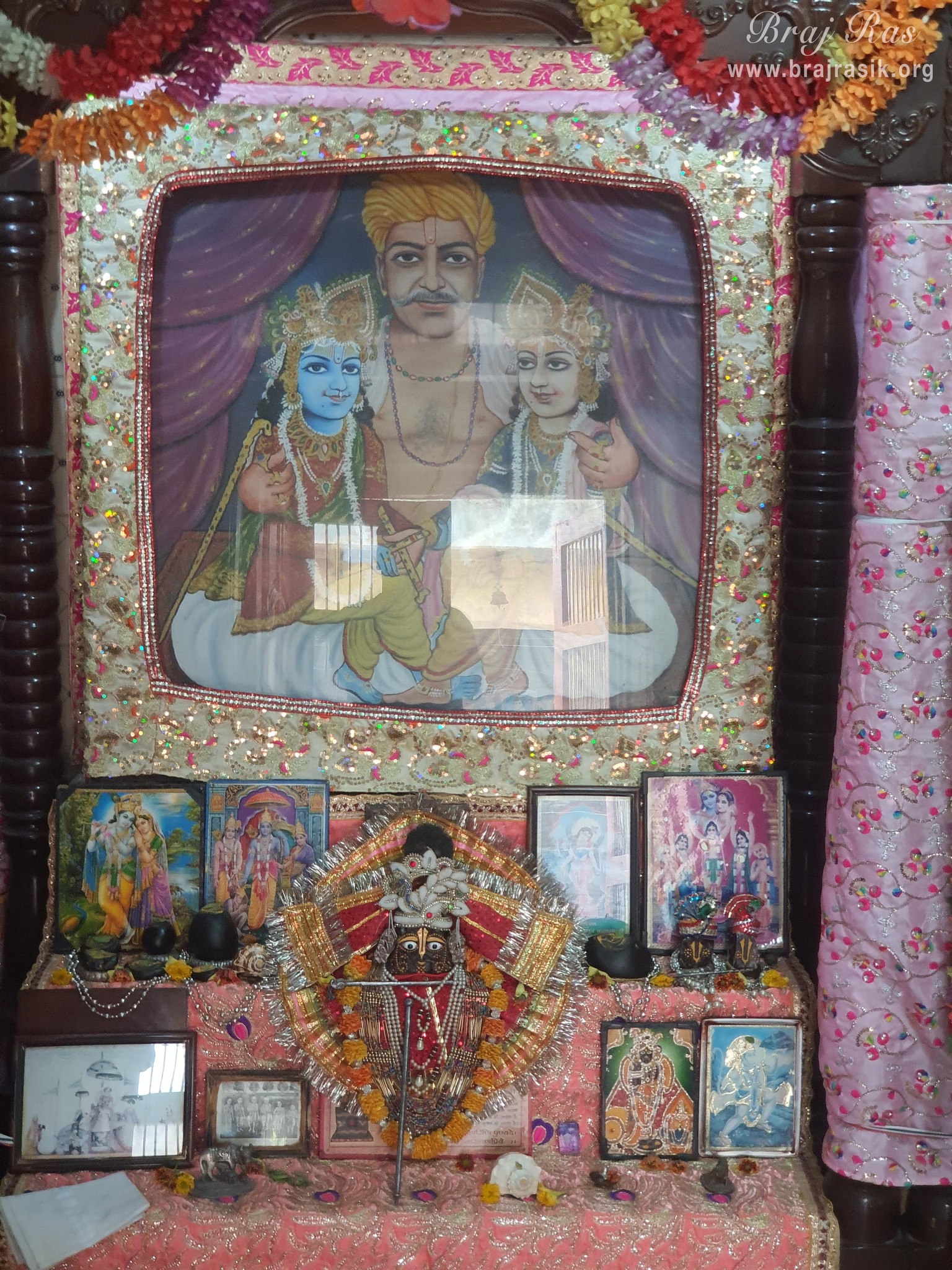 Close darshan of Krishn and Balram seated on the lap of Maharaj Nand in Nand Baithak in Nandgaon.