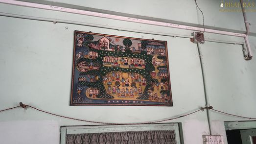 View of a picture depicting various pastimes of Shri Radha Krishn hanging on a wall inside Bhagwat Niwas, Vrindavan.