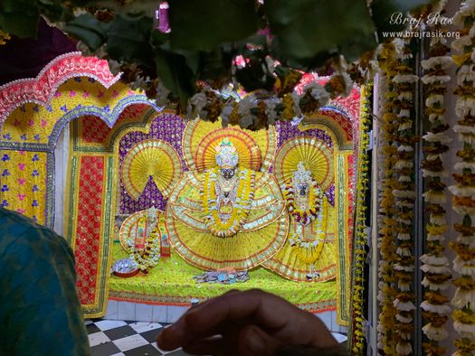 Distant darshan of Shri Krishna who is seated on Garud Ji, Goddess Lakshmi is seated on the left of Krishna, inside Garud Govind Temple near Vrindavan.