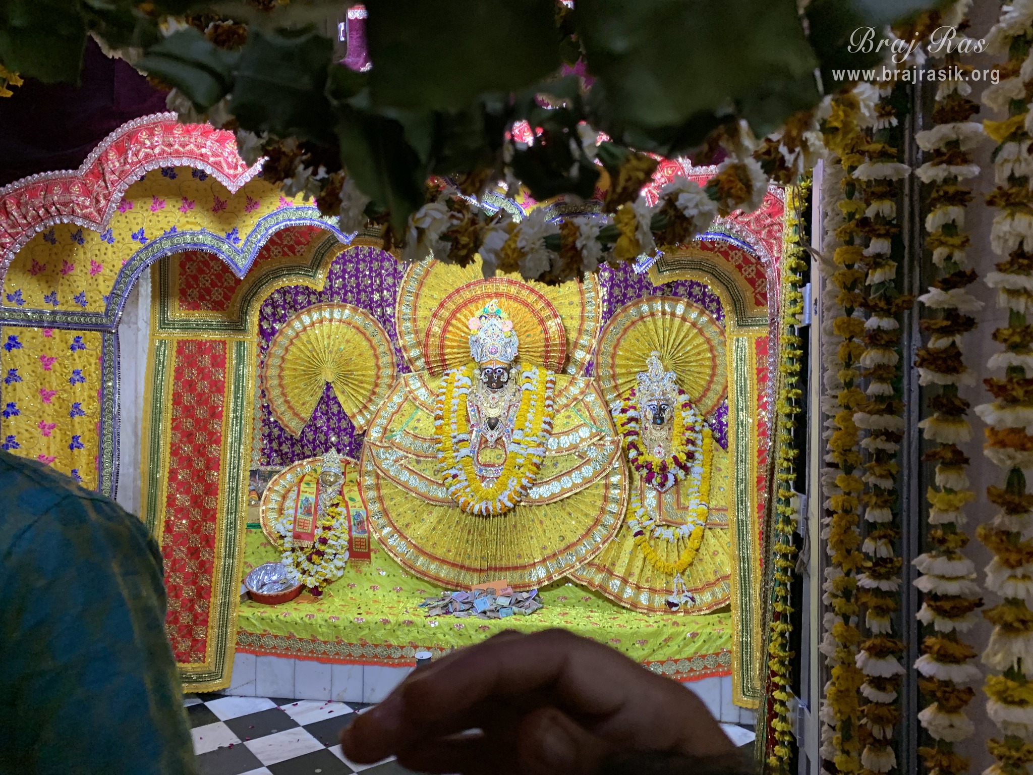 Distant darshan of Shri Krishna who is seated on Garud Ji, Goddess Lakshmi is seated on the left of Krishna, inside Garud Govind Temple near Vrindavan.