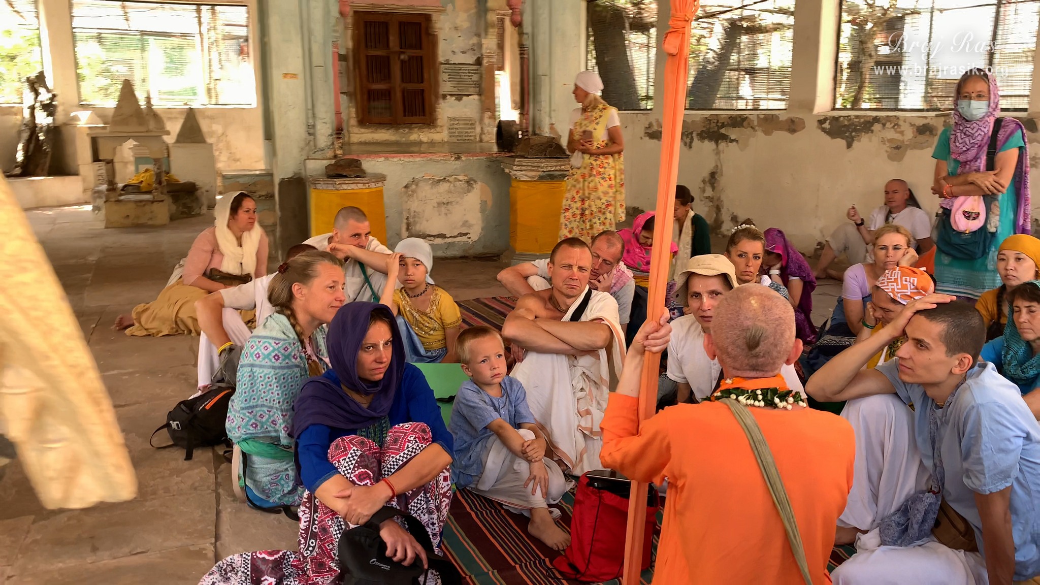 The Vaishnavas from foreign countries are listening to the pastimes of the deities of the temple by a Dandi Sanyasi devotee, in Shri Radha Gokulanand Temple, Vrindavan.