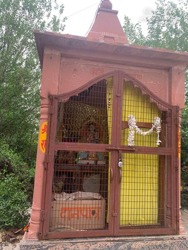Queen Kirti with Shri Radha on her lap in Kirti Tapah Sthali inside Khelan Van, Padar Van, Barsana.