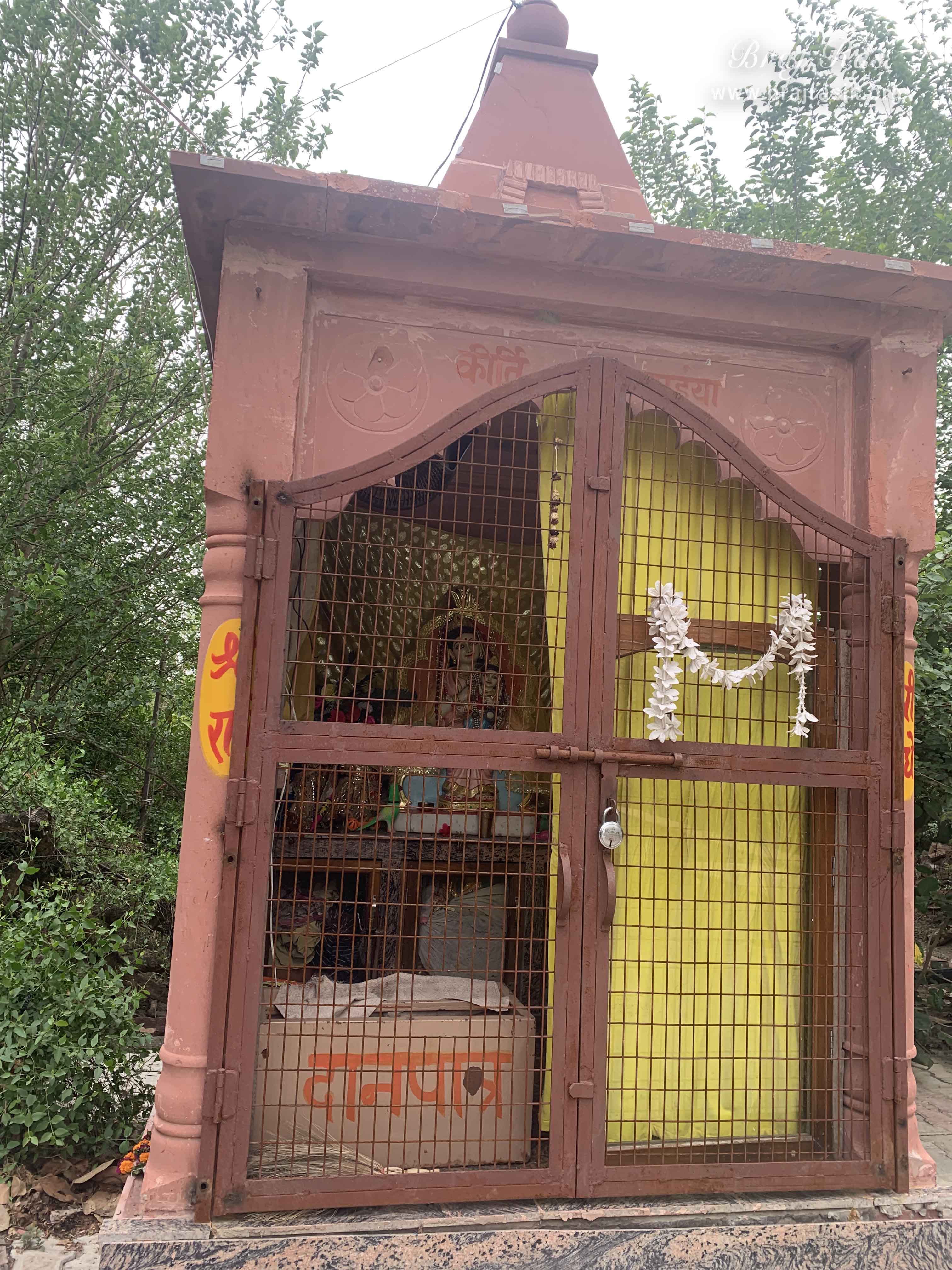 Queen Kirti with Shri Radha on her lap in Kirti Tapah Sthali inside Khelan Van, Padar Van, Barsana.